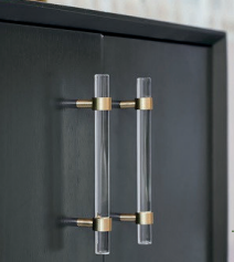 Clear acrylic and brass T-bar handle from Brass Essence collection, showcasing sleek, modern hardware for furniture or cabinetry.