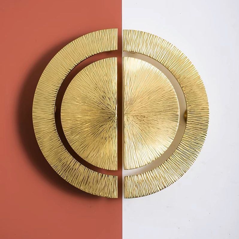Pair of hammered brass half-circle pulls from Brass Essence, showing textured, brass finish cabinet handles on a light background.