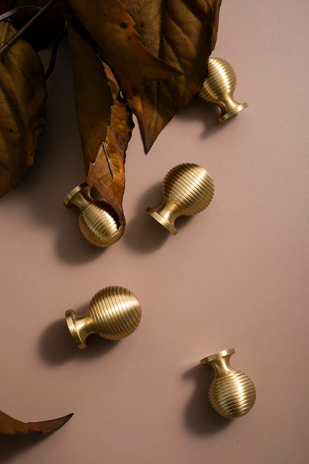 Brass essence Alexander & Wicks brass knob with luxury brushed finish, showcasing a sleek, rounded design for furniture or cabinetry.
