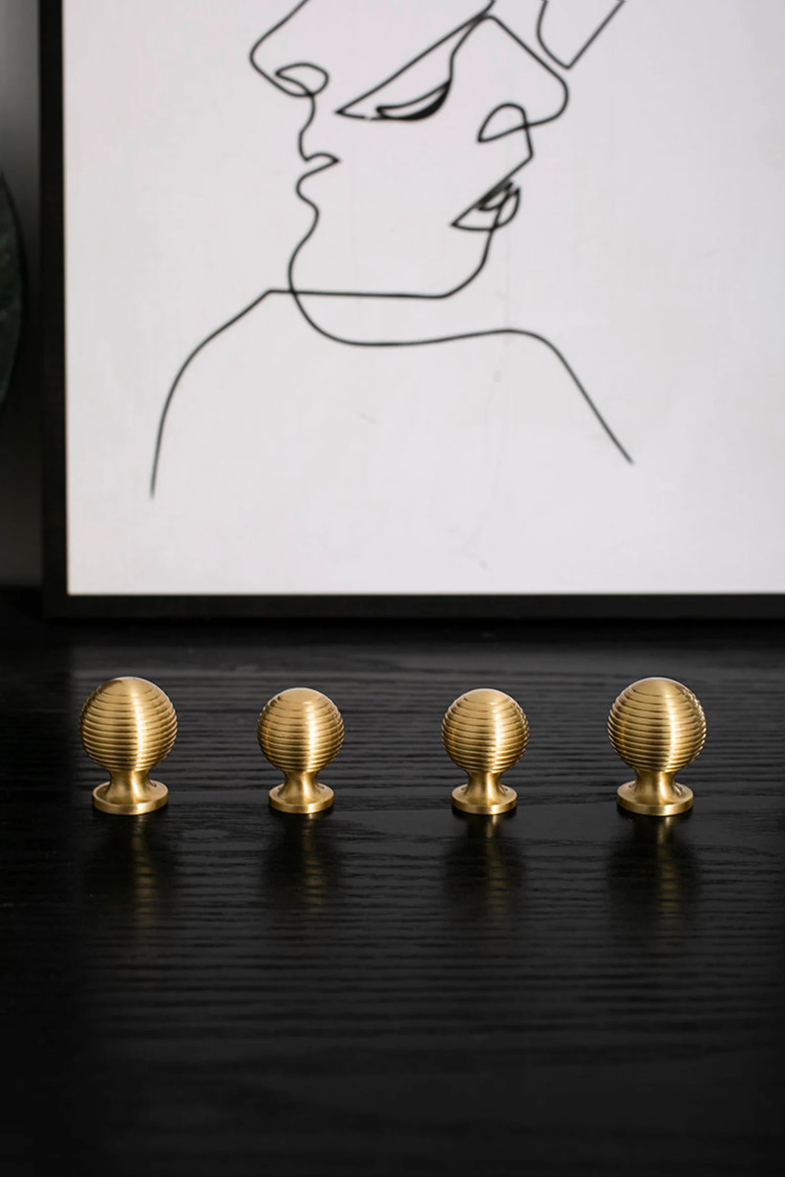 Brass Essence Alexander & Wicks brass knob with a brushed finish, showcasing a luxurious and modern hardware design.